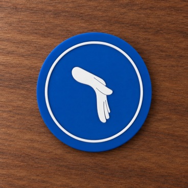 Blue circular PVC patch with a white hand symbol on a wooden surface.
