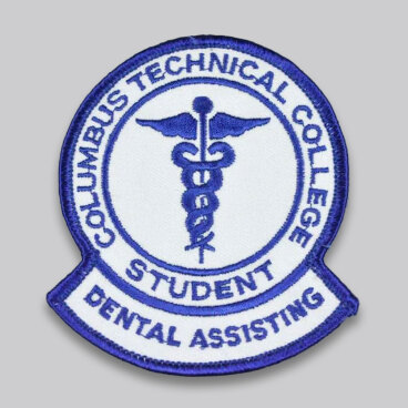 Round patch with 'Columbus Technical College Student Dental Assisting' and a caduceus symbol.