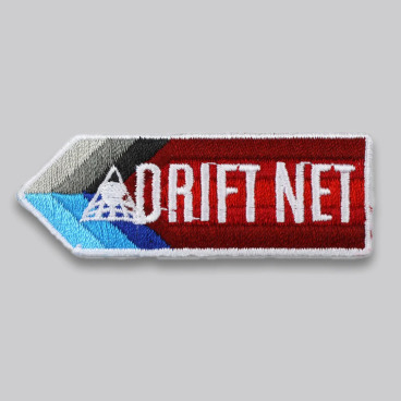 Embroidered patch with the text 'DRIFT NET' in white on a red and blue arrow-shaped background.