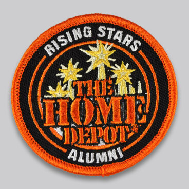 Round embroidered patch with "The Home Depot Alumni" and star designs.